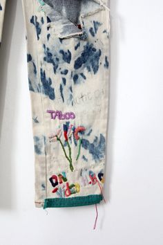 "A pair of vintage jeans circa 1980s to early 90s featuring bleach out, paint, and embroidery. The high waist denim feature a zipper fly and straight leg. Intricate hand embroidery, buttons, sequins, and paint color the denim. Rastamon style, pop culture, and inside jokes theme the custom made pants. CONDITION In good pre-owned condition. MARKED SIZE: 9/10 MEASURED SIZE: 28 x 32 MEASUREMENTS Waist: 28\" Inseam: 32\" Rise: 11\" Hips: 36\" For best fit, please compare measurements with a pair of y Paint And Embroidery, Painted Embroidery, Gap Clothing, Embroidery Buttons, 80s Jeans, Gap Outfits, Custom Denim, Loose Jeans