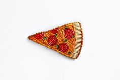 a piece of brooch that has been made to look like a slice of pizza