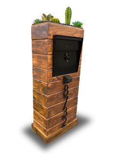 an old fashioned wooden box with plants growing out of it's top and the door open