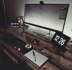 a desktop computer sitting on top of a wooden desk next to a keyboard and mouse