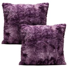 a purple pillow that is made out of faux fur and has been placed on a white background