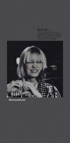 a black and white photo of a woman holding a microphone with the words love written on it