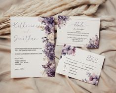 the wedding stationery is laid out on a bed