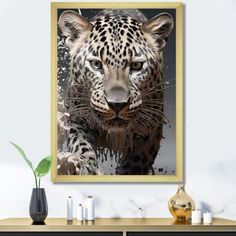 a framed photograph of a snow leopard in front of a white wall with candles on it