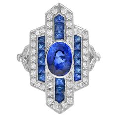 This gorgeous vintage inspired sapphire and diamond cocktail ring truly capture the iconic stylish aesthetic of the Art Deco era! The chic geometric design is adorned with 1.6 carat Ceylon sapphire, glitters with vibrant white diamonds and French cut sapphires. The vibrant color of sapphire and brilliance of diamonds makes a powerful combination. Ring Information Style: Art-deco Metal: Platinum950 Total weight: 10.30 g. (approx. total weight) Center Gemstone Type: Ceylon Sapphire Shape: Oval Siz Stylish Aesthetic, Diamond Cocktail Ring, Ceylon Sapphire, French Cut, Diamond Cocktail Rings, Art Deco Era, Art Deco Style, Cocktail Ring, The Chic