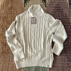 Brand New Old Ranch Cream Sweater With Classic Fisher Knit Design With Unique Neckline Fitted Cotton Cream Sweater, Fitted Cream Cotton Sweater, Classic Cream Tops For Winter, Cream Fitted Cable Knit Top, Fitted Beige Cable Knit Sweater, Fitted Cream Cable Knit Top, Cozy Fitted Top With Ribbed Collar, Cream Cable Knit Tops For Fall, Fitted Winter White Sweater For Fall