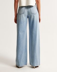 Elevate your wardrobe with the Abercrombie & Fitch Women's High Rise Wide Leg Jeans, a perfect blend of comfort and style. These jeans feature a flattering 10.5” high rise and flow into a relaxed, full-length wide leg. Crafted from a unique blend of soft, lightweight rigid denim and eco-friendly TENCEL™ Lyocell fibers, these jeans ensure both sustainability and durability.

- Size: 34 LONG
- Color: Light Wash
- Material: Cotton, TENCEL™ Lyocell
- Gender: Female
- Fit: High rise, relaxed at the w Light Wash Relaxed Fit High-waisted Bottoms, Light Wash High-waisted Relaxed Fit Bottoms, High-waisted Light Wash Relaxed Fit Bottoms, Wide-leg Light Wash Cotton Bottoms, Light Wash Relaxed Fit Wide-leg Bottoms, High Rise Wide Leg Jeans, Denim Fabric, Leg Jeans, Wide Leg Jeans