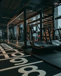 an empty gym with treadmills and exercise machines