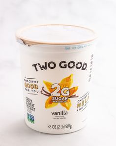 two good yogurt is shown on a white surface with the words, 2g sugar vanilla