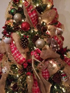 a christmas tree decorated with burlocks and ornaments