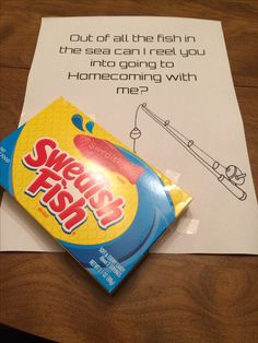 a candy bar sitting on top of a table next to a piece of paper that says sweet fish