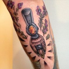 a man with a tattoo on his leg that has an object in the middle of it