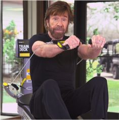 a man sitting on top of a chair holding a pair of scissors in his hands