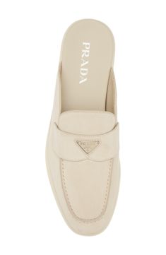 Prada's iconic triangular logo shines at the keeper strap of this easygoing loafer mule crafted of velvety suede in a desert-inspired hue. Leather upper and lining/synthetic sole Made in Italy Designer Shoes Luxury Slip-on Mules With Removable Insole, Luxury Slip-on Mules With Branded Insole, Designer Suede Loafers With Flat Heel, Luxury Suede Loafers For Spring, Luxury Mules With Rubber Sole, Luxury Beige Suede Loafers, Luxury Suede Mules For Formal Occasions, Designer Beige Leather Mules, Luxury Beige Leather Mules