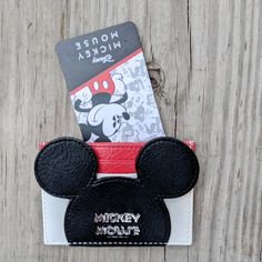 a mickey mouse wallet with a credit card in it