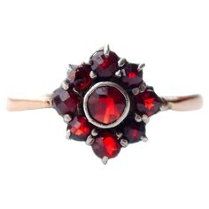 A Ring with Red Flower, since 1941. Crown in Silver Ø 10 mm /3mm deep. Band in solid 18K Rose Gold + 9 natural rose cut Red Bohemian Garnets of Pyrope variety with open backs. This ring was made in Stockholm, Sweden in 1941 /year marks P8. Size: Ø 5 US / 15.7 mm. Sizing is possible for additional payment. Weight: 1.3 gram In fine used condition. Natural age patina on metal. > Most of the items that we sell are not new at all if not stated otherwise. Accordingly, most of the items most often show Rose Gold Crown, Open Backs, Old Rings, Book Photo, Photo Equipment, Stockholm Sweden, Old Jewelry, Red Garnet, Natural Red