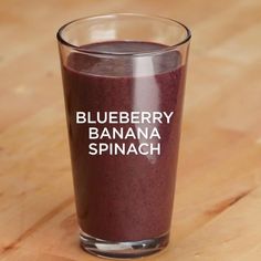 blueberry banana spinach smoothie in a glass with the words blueberry banana spinach on it