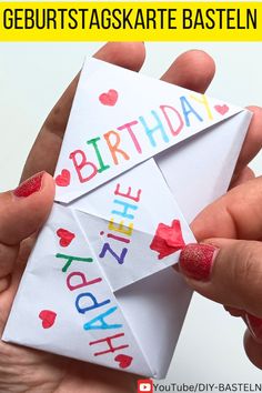 two hands holding an origami birthday card