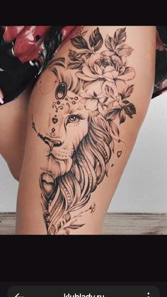 a woman's thigh with a lion and roses tattoo on the side of her leg