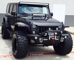 a black jeep parked in front of a building