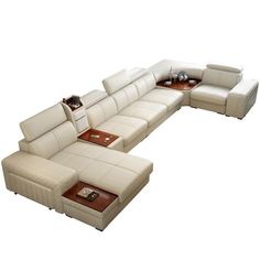 a large sectional couch sitting on top of a white floor next to a coffee table