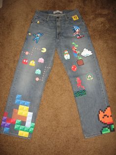 an old pair of jeans with video game characters on them, sitting on the floor