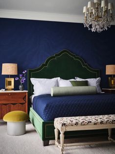 a bedroom with blue walls and green headboard