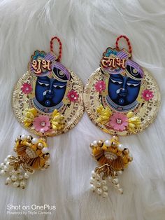 pair of earrings with buddha face and pearls