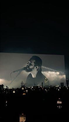 a man that is standing in front of a screen