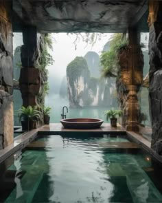 an indoor swimming pool surrounded by rocks and water features a large stone bathtub in the middle