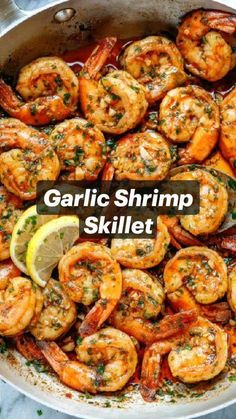 garlic shrimp skillet in a pan with lemon wedges