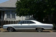 a silver car parked in front of a house