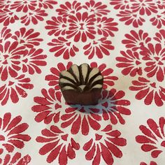 a small cupcake sitting on top of a red and white table cloth