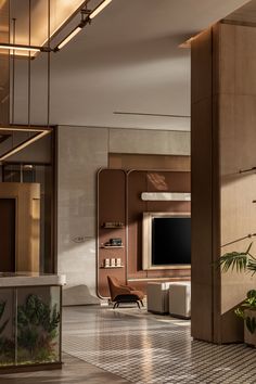 a living room filled with furniture and a flat screen tv mounted on a wall next to potted plants