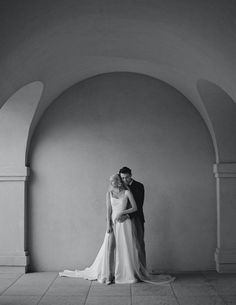 black and white photo of bride and groom in an archway at the end of their wedding day