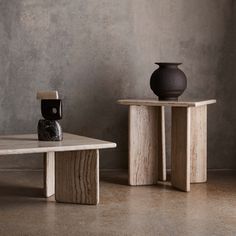 two wooden tables with vases on top of them