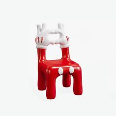 a red and white plastic chair on a white background