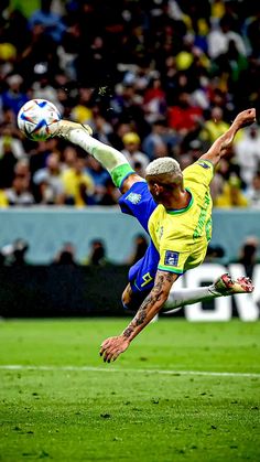 a soccer player is kicking the ball during a game