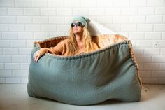 a woman sitting in a bean bag chair with her hands on the back of it