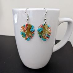 These lightweight earrings are made with colorful resin leaf pendants and nickel free ear wires. Dangle length is approximately 1 inch, not including ear wires. To extend the life of your earrings, avoid contact with sweat, lotions, and other chemicals. Please message me with any questions. To see other earring options, check out my full store: https://www.etsy.com/shop/shopcraftyoctopus/ Multicolor Glass Earrings With Colorful Beads, Multicolor Glass Beaded Earrings, Multicolor Hypoallergenic Flower Earrings Gift, Multicolor Glass Beaded Earrings For Gift, Multicolor Nickel-free Dangle Flower Earrings, Nickel Free Multicolor Dangle Flower Earrings, Nickel-free Multicolor Dangle Flower Earrings, Multicolor Leaf Shaped Jewelry For Gifts, Multicolor Leaf-shaped Jewelry Gift