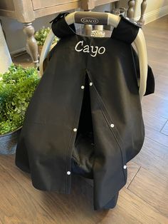 a chair covered in black leather with the word cayo on it's back