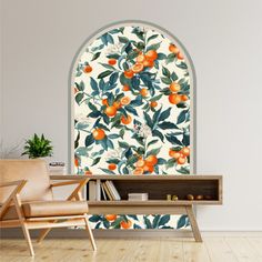 an orange tree wallpaper mural in a living room with a chair and bookcase