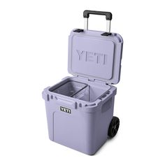 a purple yeti cooler with wheels is shown on a white background and has the lid open