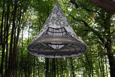 the sky pod is suspended in the woods