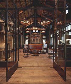 a large room with wooden floors and glass walls