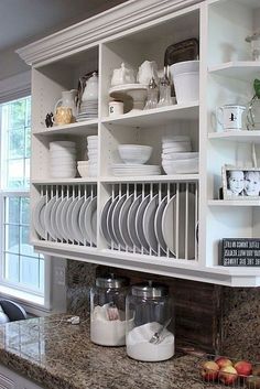 a kitchen counter with plates and bowls on it