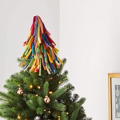 a small christmas tree decorated with colored pencils