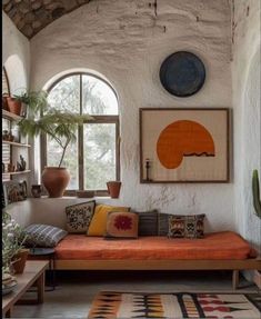 a living room with an orange couch and potted plants