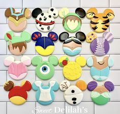 mickey mouse and other disney character cookie toppers on a white tile background with the words sweet delila's