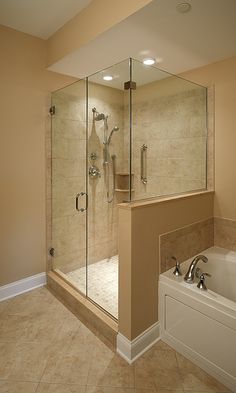 a bathroom with a walk in shower next to a bath tub